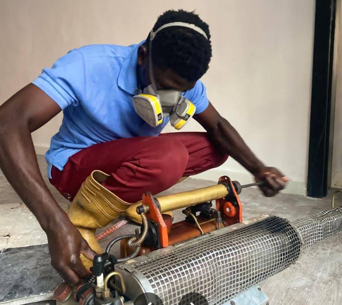 Technician preparing fogging equipment for a pest control treatment